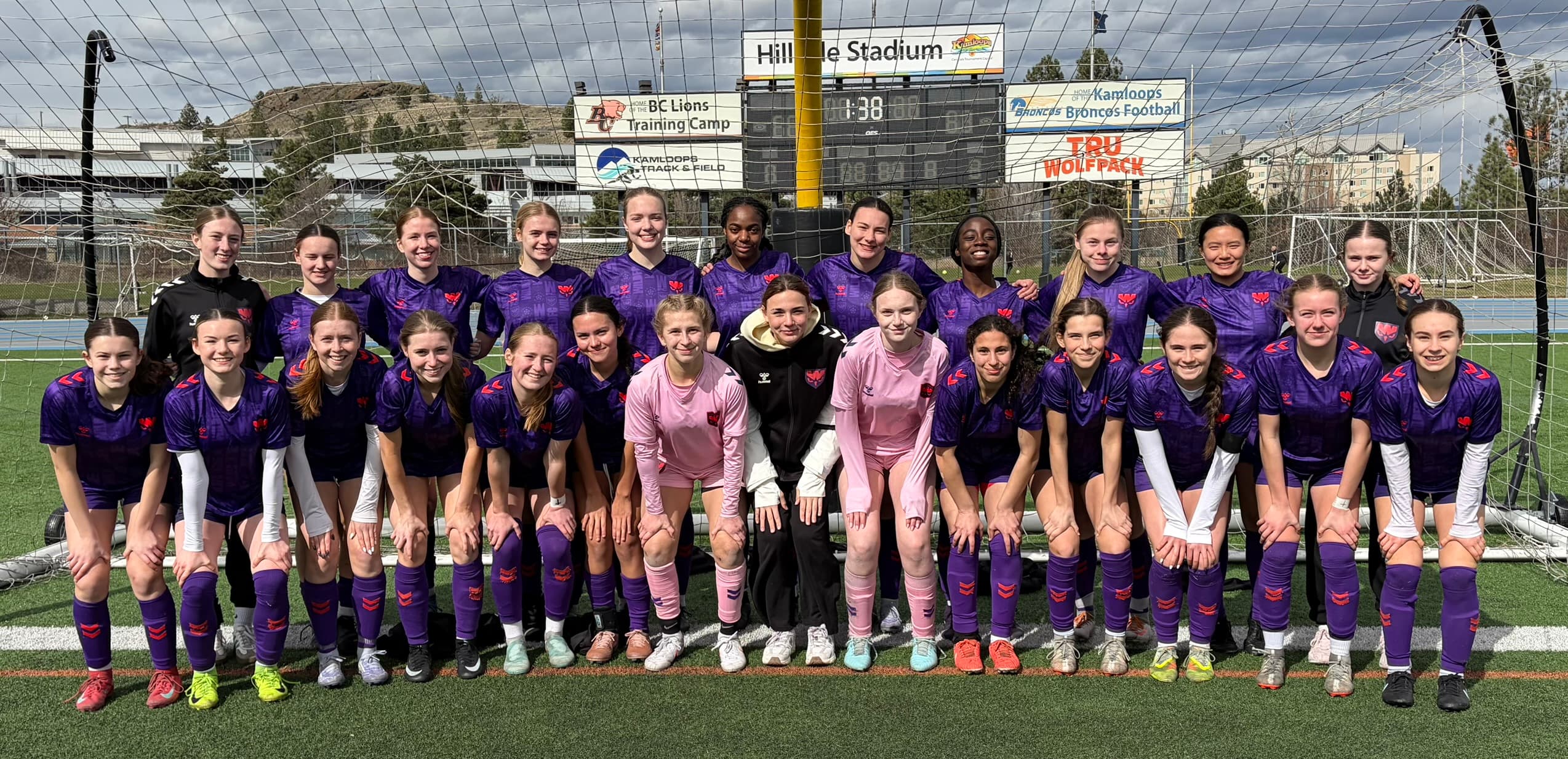 Wild Academy players posing together in front of a soccer goal.